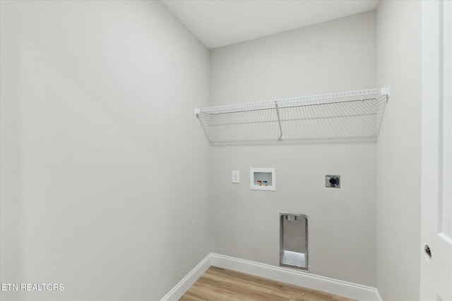 clothes washing area featuring baseboards, laundry area, hookup for a washing machine, and hookup for an electric dryer