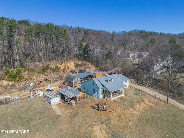 birds eye view of property featuring a view of trees