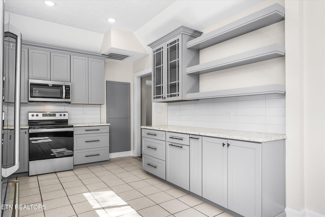 kitchen with stainless steel appliances, gray cabinets, visible vents, and open shelves