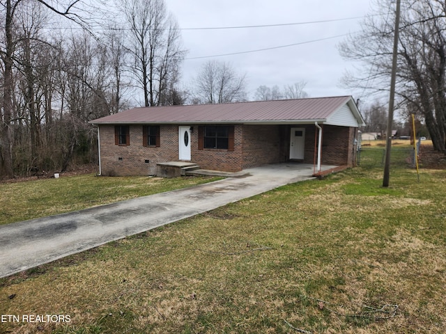 view of front of home featuring metal roof, brick siding, driveway, crawl space, and a front lawn