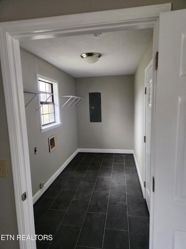 laundry area featuring hookup for a washing machine, hookup for a gas dryer, dark tile patterned floors, baseboards, and electric panel