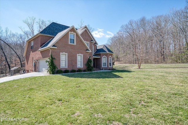 traditional-style home with a garage, a front yard, concrete driveway, and brick siding