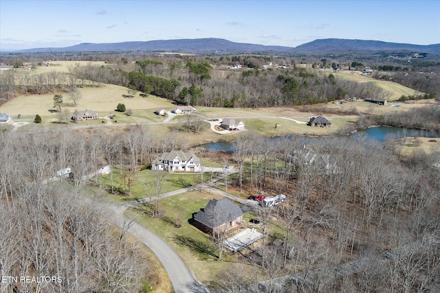 birds eye view of property featuring a rural view and a water and mountain view