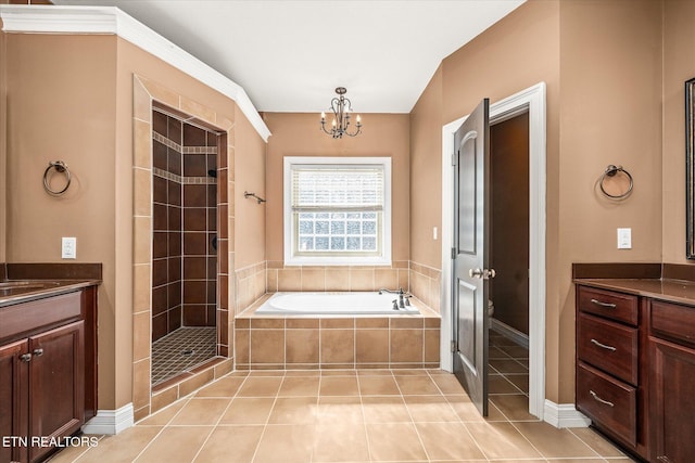 full bath featuring a bath, a shower stall, vanity, and tile patterned floors