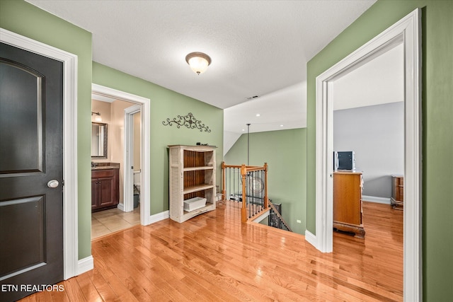 interior space with wood finished floors, visible vents, and baseboards