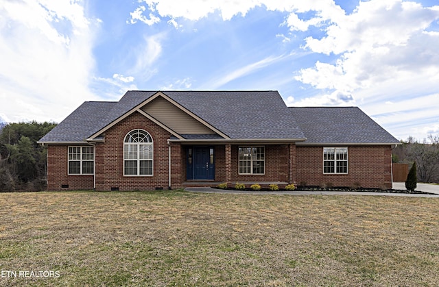 view of front of house featuring crawl space, roof with shingles, a front yard, and brick siding