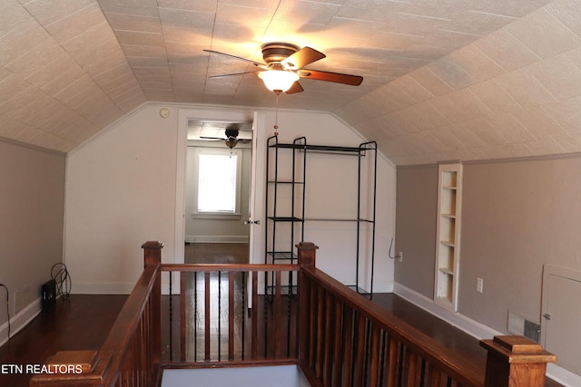 bonus room with lofted ceiling, built in shelves, wood finished floors, and baseboards