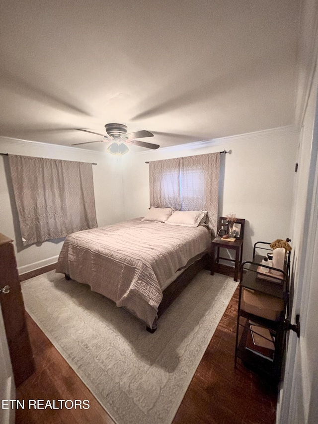 bedroom with dark wood-type flooring and ceiling fan