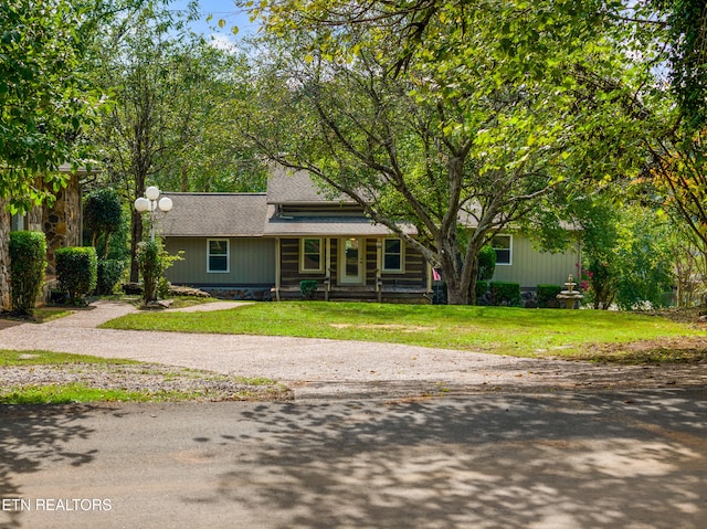 view of front of home featuring covered porch and a front lawn