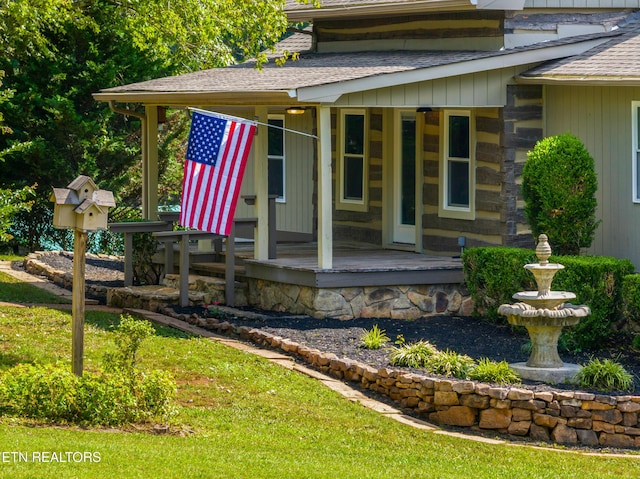 exterior space featuring a shingled roof and a porch