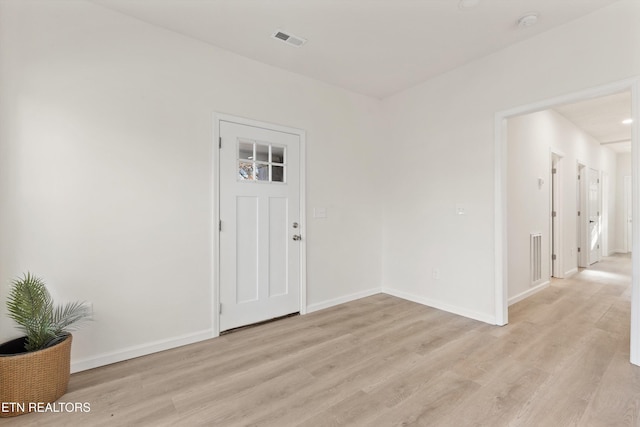 entrance foyer featuring light wood-style flooring, visible vents, and baseboards