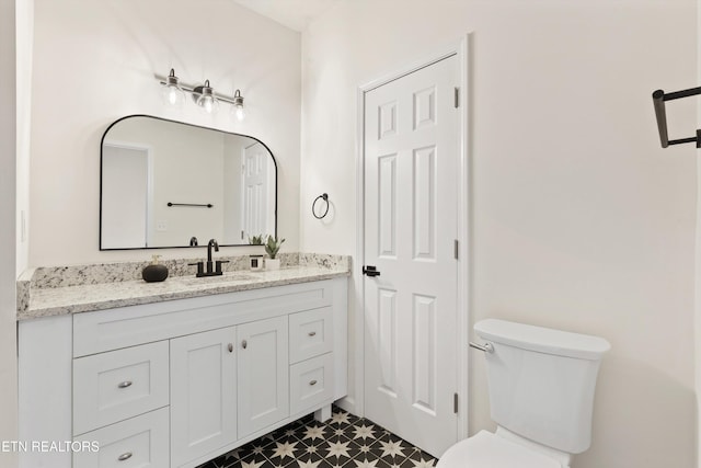 bathroom featuring toilet and vanity