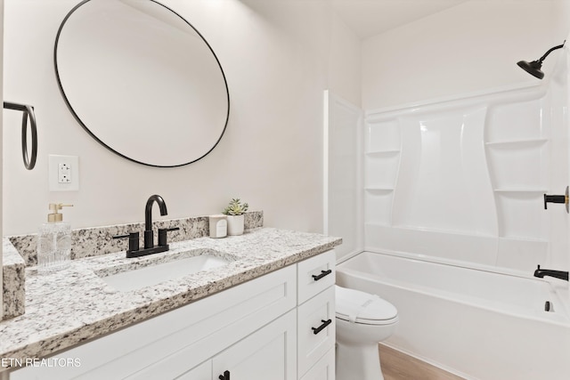 full bathroom featuring wood finished floors, shower / washtub combination, vanity, and toilet