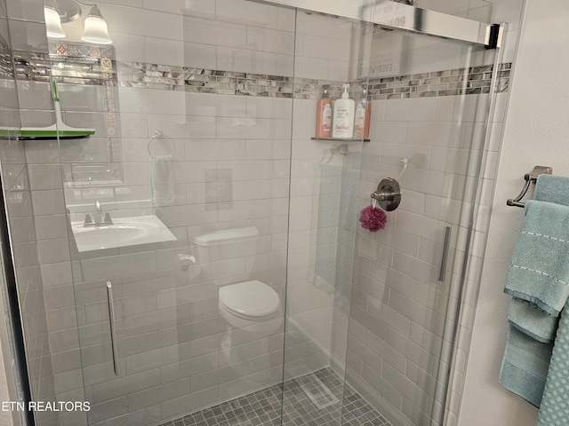 full bath with toilet and a stall shower