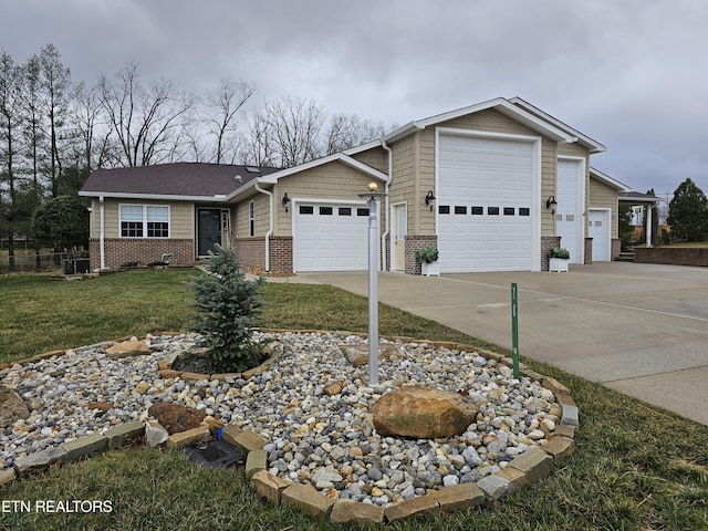 view of front of home featuring a garage, a front yard, concrete driveway, and brick siding