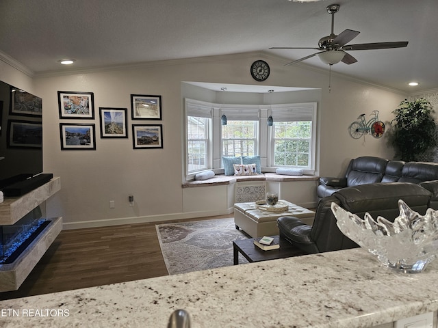 living room featuring lofted ceiling, crown molding, and wood finished floors