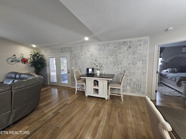 dining room featuring ornamental molding, wood finished floors, and wallpapered walls