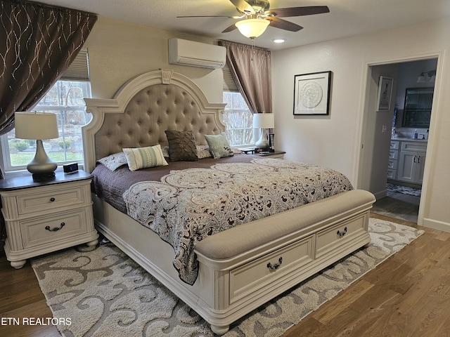 bedroom featuring light wood finished floors, multiple windows, and a wall mounted air conditioner