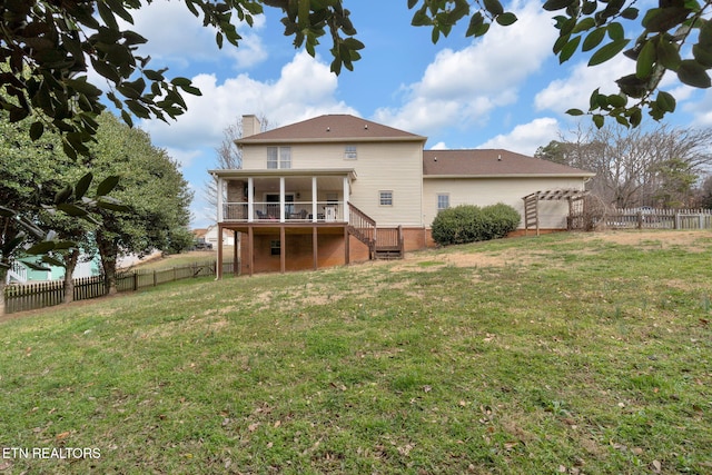 rear view of property with a fenced backyard, a chimney, stairway, and a yard