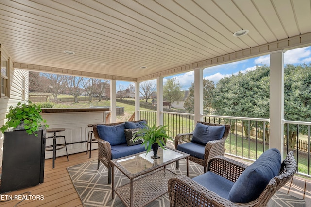 sunroom / solarium featuring baseboard heating and a wealth of natural light