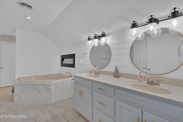 bathroom with double vanity, visible vents, a sink, and tile patterned floors