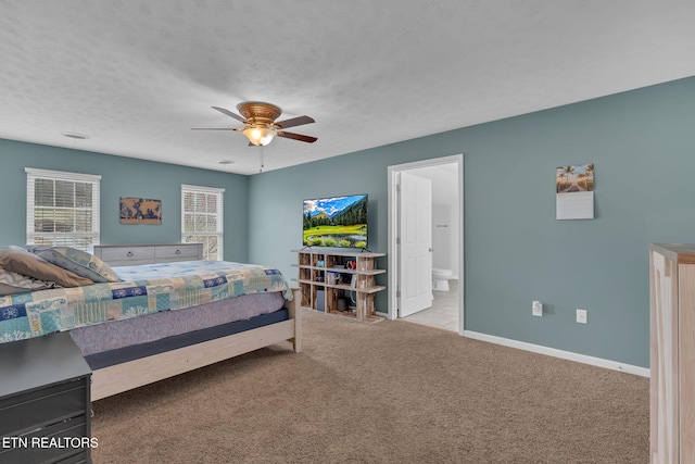 carpeted bedroom with ceiling fan, baseboards, a textured ceiling, and ensuite bathroom