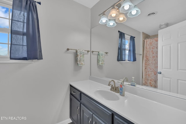 full bath featuring visible vents, vanity, and a shower with shower curtain