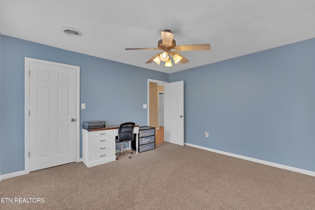 carpeted home office with ceiling fan, visible vents, and baseboards