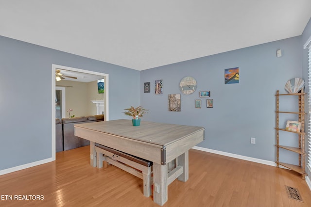 dining space with light wood-style floors, visible vents, baseboards, and a ceiling fan