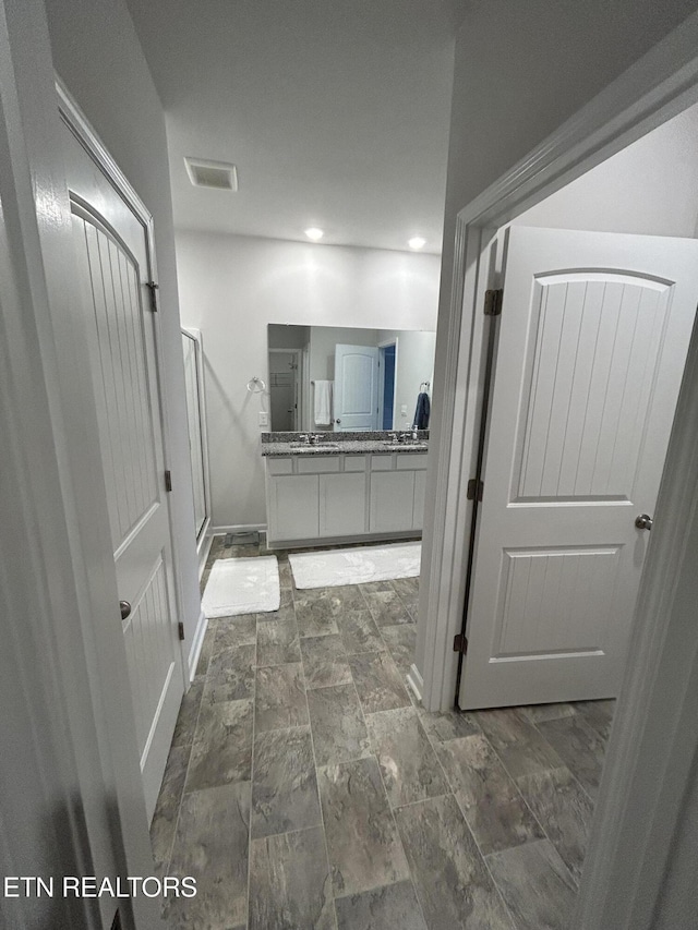 bathroom with visible vents, baseboards, vanity, a shower stall, and recessed lighting