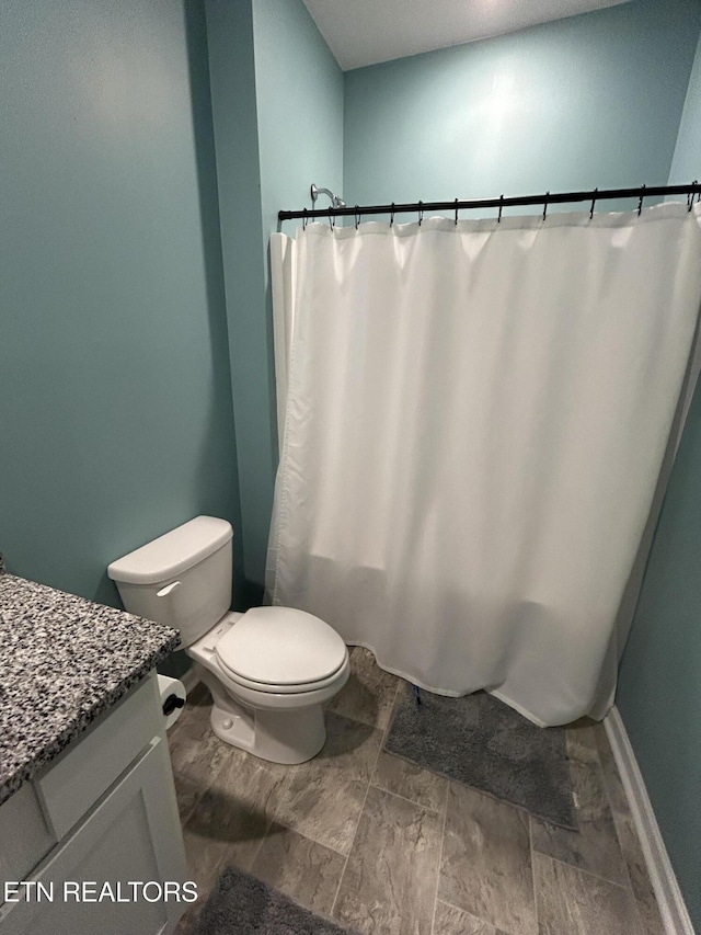 bathroom featuring toilet and vanity