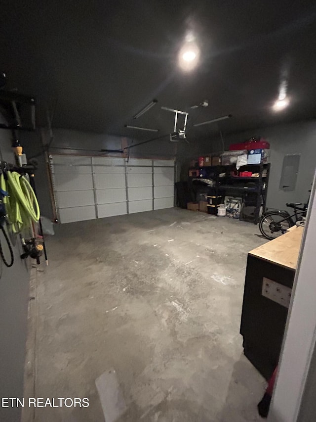 garage featuring electric panel and a garage door opener