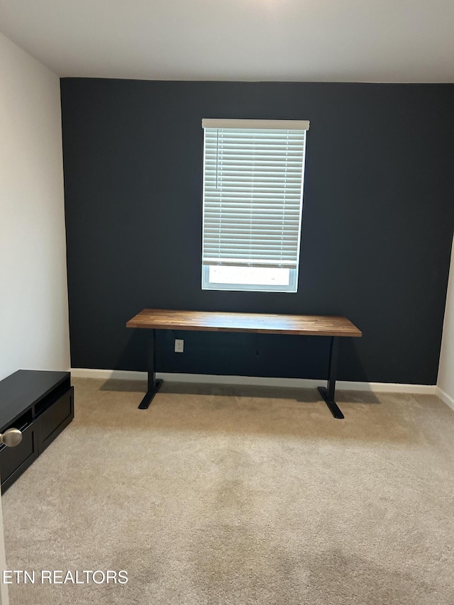 interior space with carpet floors and baseboards