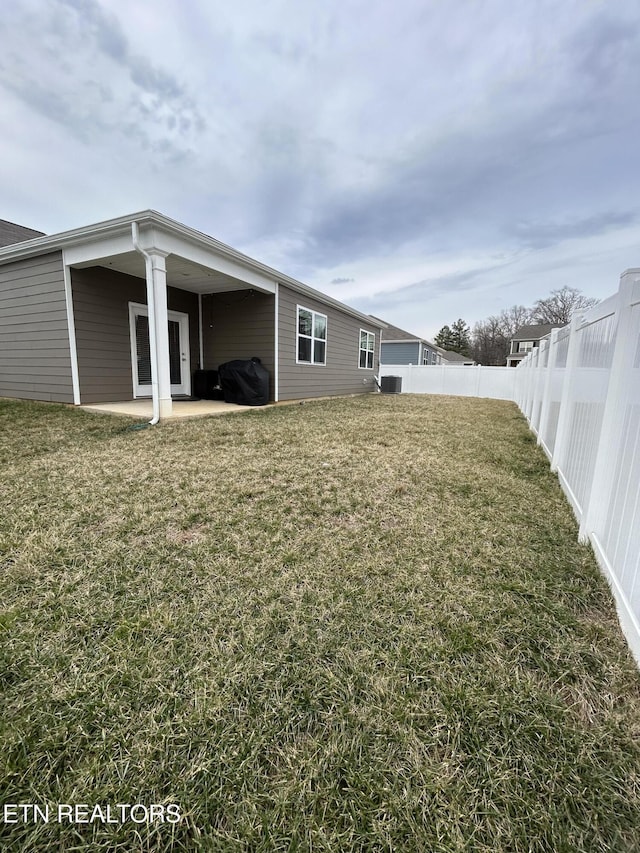 view of yard featuring a patio area and a fenced backyard