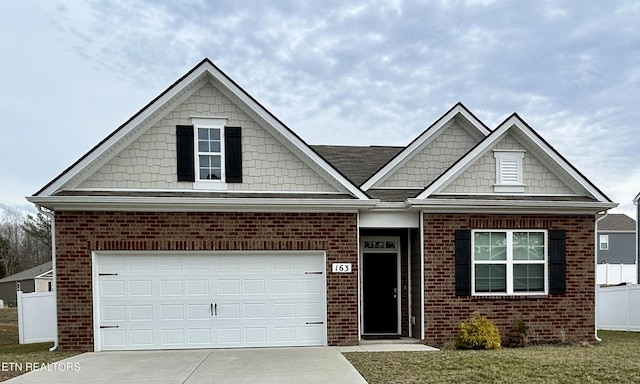 view of front of house with a garage, driveway, and brick siding