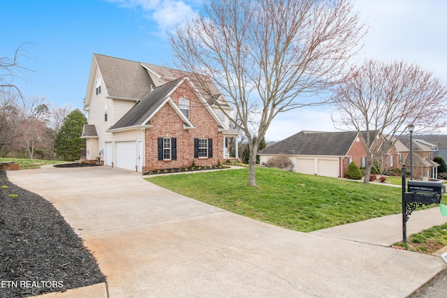 view of front of home featuring brick siding, roof with shingles, concrete driveway, and a front yard