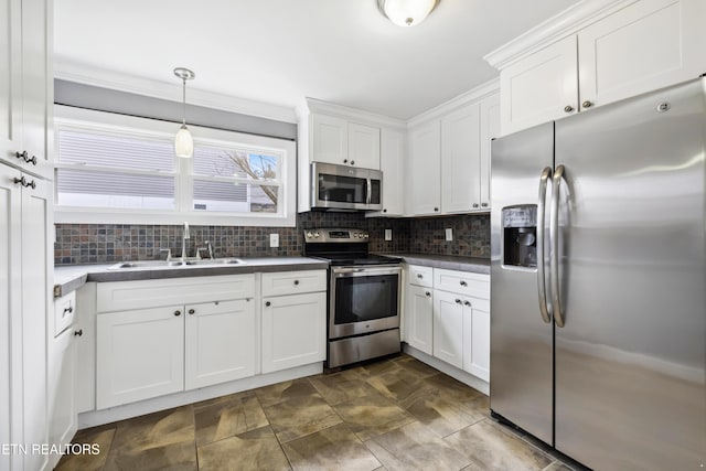 kitchen with stainless steel appliances, white cabinets, a sink, and decorative backsplash