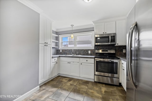 kitchen with white cabinets, appliances with stainless steel finishes, backsplash, and a sink