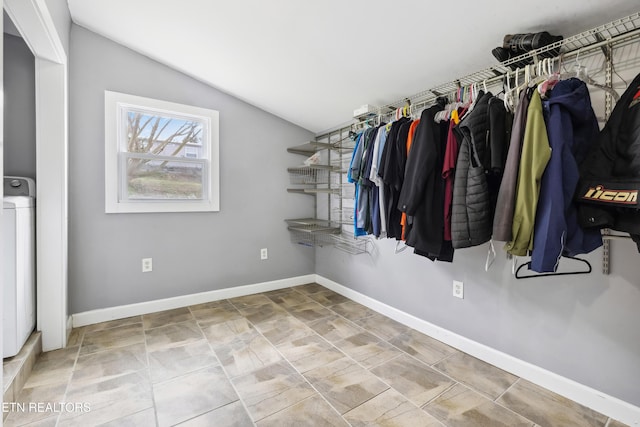 walk in closet featuring washer / dryer and lofted ceiling