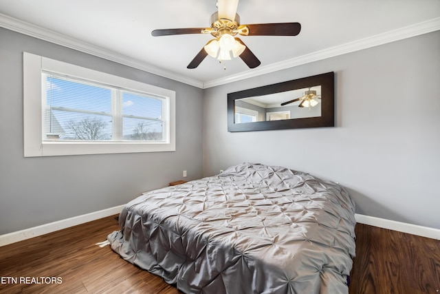 bedroom featuring ornamental molding, wood finished floors, a ceiling fan, and baseboards