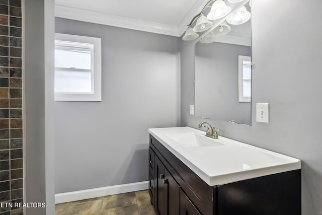 bathroom featuring ornamental molding, vanity, a wealth of natural light, and baseboards