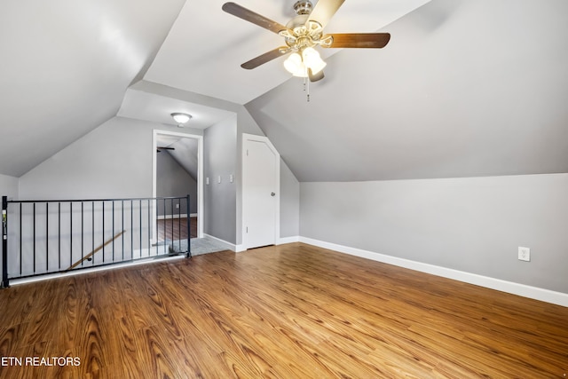 bonus room featuring vaulted ceiling, ceiling fan, wood finished floors, and baseboards