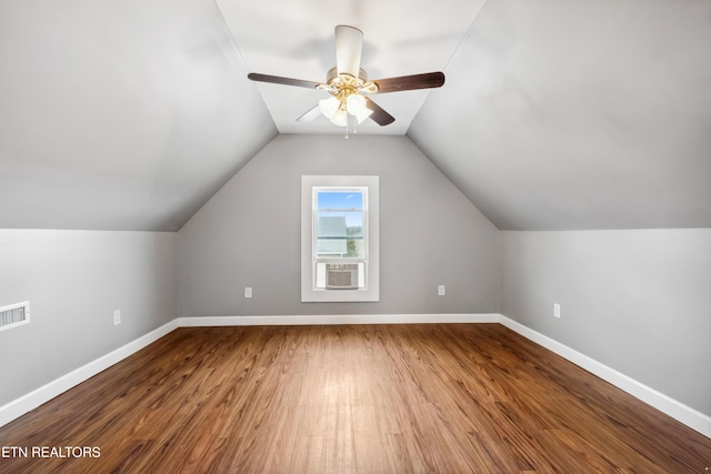 bonus room with ceiling fan, baseboards, vaulted ceiling, and wood finished floors