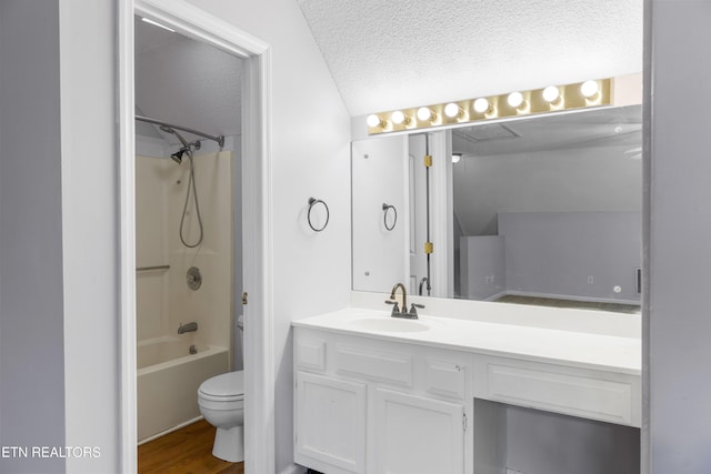 full bath featuring toilet, shower / tub combination, vanity, wood finished floors, and a textured ceiling