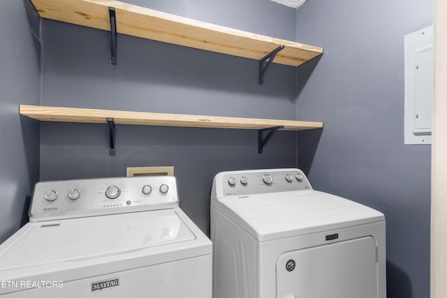 washroom featuring electric panel, laundry area, and washing machine and clothes dryer
