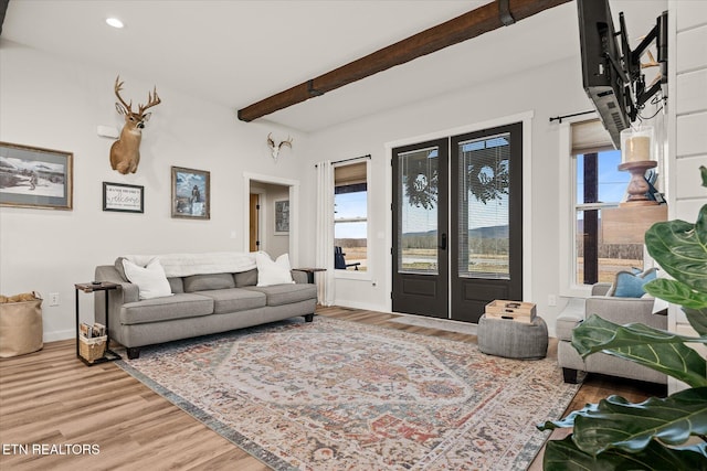 living room with baseboards, wood finished floors, french doors, beam ceiling, and recessed lighting