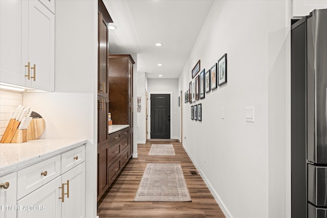 hall with recessed lighting, baseboards, and wood finished floors