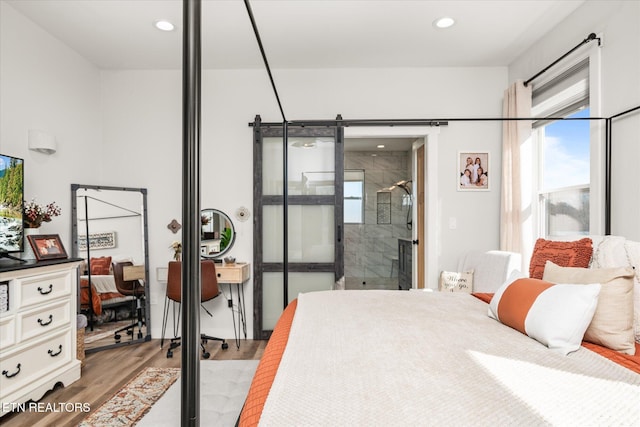 bedroom with light wood finished floors and recessed lighting