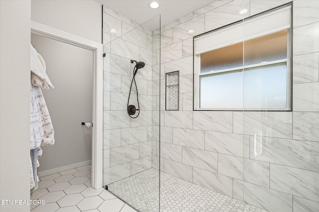 bathroom featuring baseboards and walk in shower