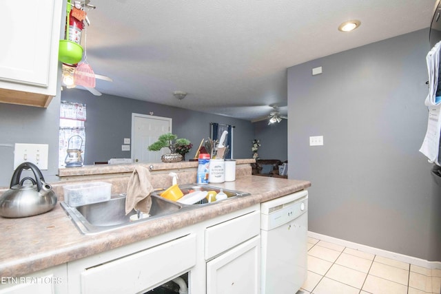 kitchen with ceiling fan, light tile patterned flooring, a sink, white cabinets, and dishwasher